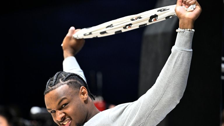 Southern California guard Bronny James stretches as teammates warmed up...