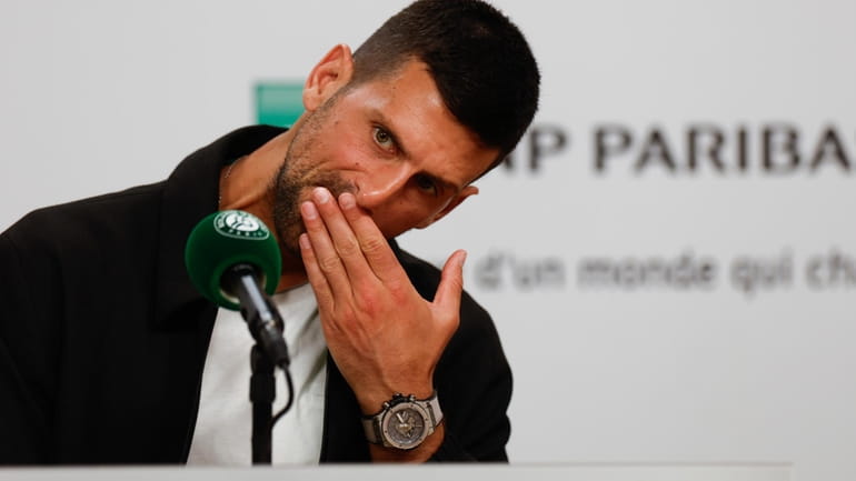 Serbia's Novak Djokovic ponders a question during a press conference...