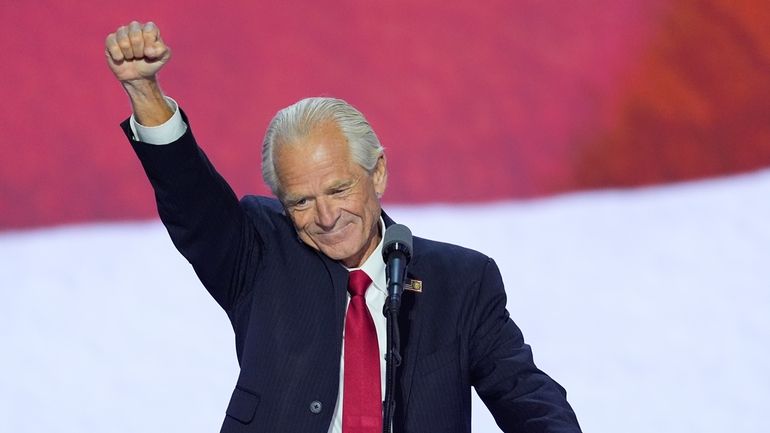 Peter Navarro raises his fist while speaking during the Republican...