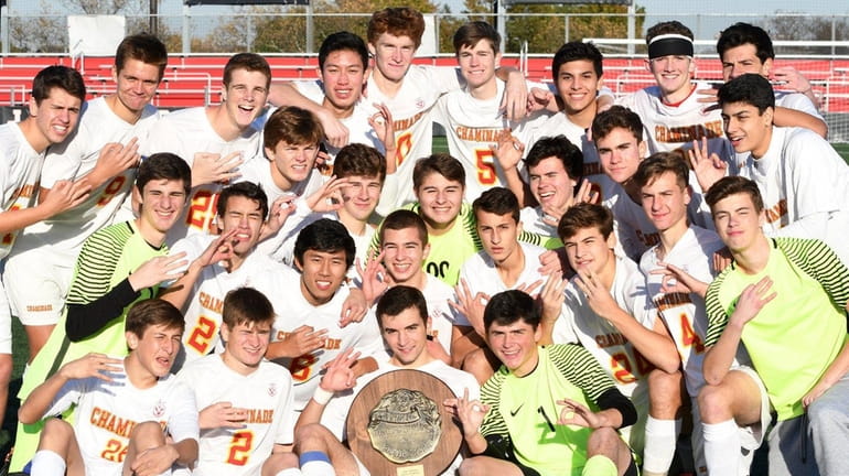 Three-peat! Chaminade's players pose with the championship trophy after the...