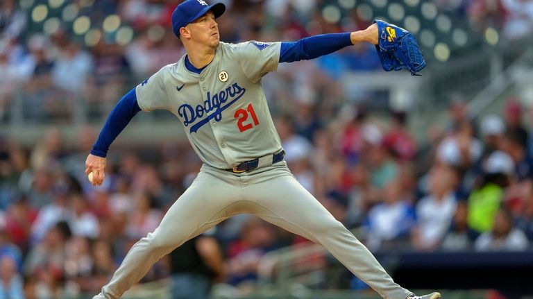 Los Angeles Dodgers pitcher Walker Buehler throws in the first...