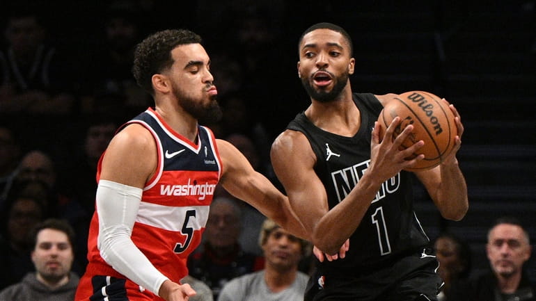 Nets forward Mikal Bridges is defended by Washington Wizards guard...