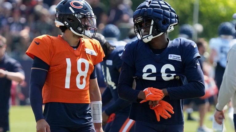 Chicago Bears quarterback Caleb Williams, left, talks with wide receiver...