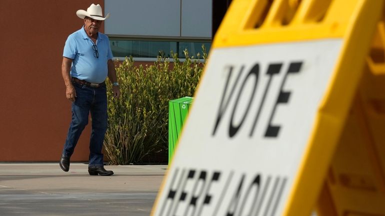 A voter leaves a precinct after casting their ballot in...