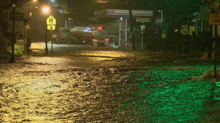 Port Jefferson is heavily flooded as the the remnants of...