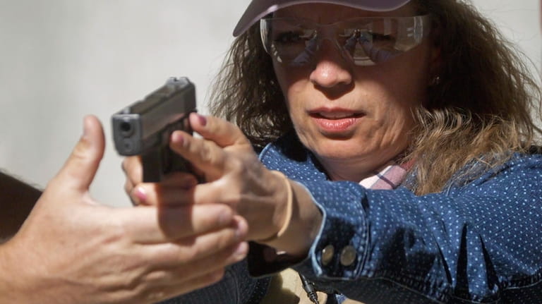 Cindy Bullock, Timpanogos Academy secretary, participates in shooting drills at...