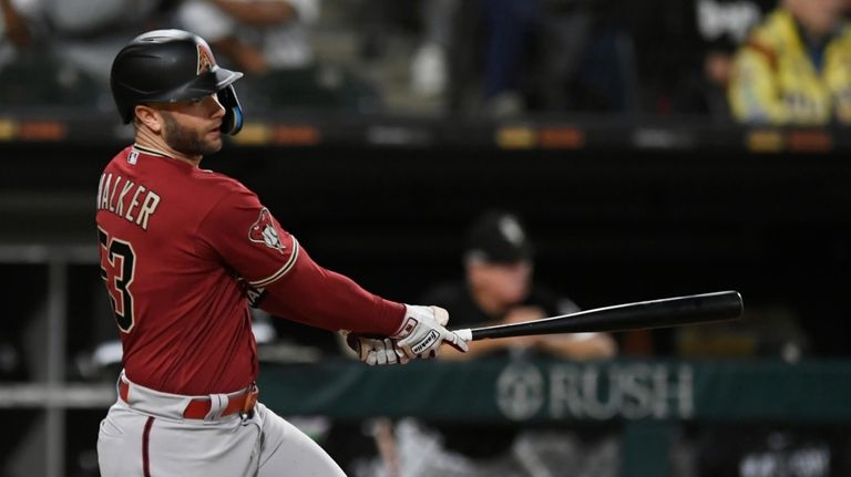 Arizona Diamondbacks' Christian Walker watches his three-run triple against the...