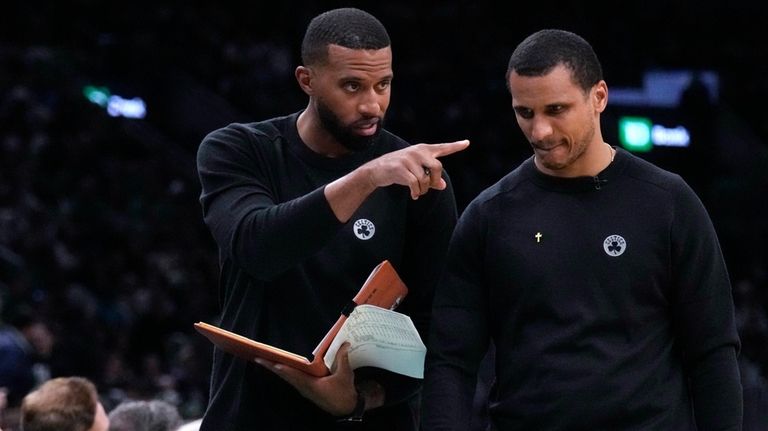 Boston Celtics assistant coach Charles Lee, left, talks with head...