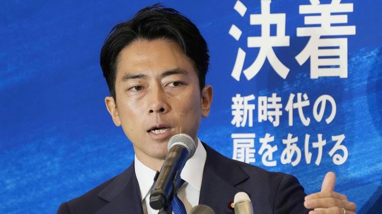 Japan's former Environment Minister Shinjiro Koizumi speaks at a news...