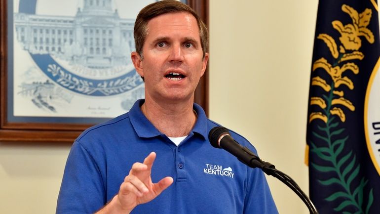 Kentucky Gov. Andy Beshear addresses a crowd gathered at the...