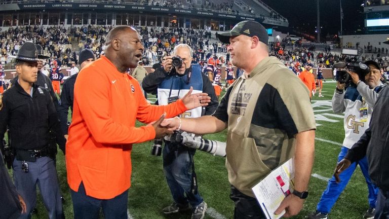 Georgia Tech coach Brent Key shakes hands with Syracuse coach...