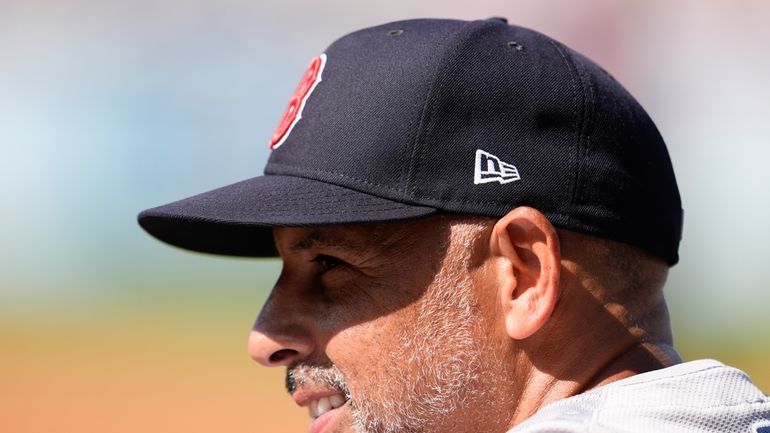 Boston Red Sox manager Alex Cora watches from the dugout...