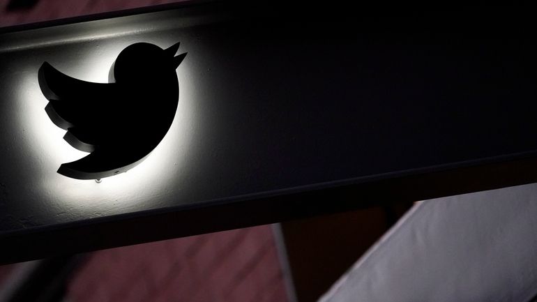 The Twitter logo is seen on the awning of the...