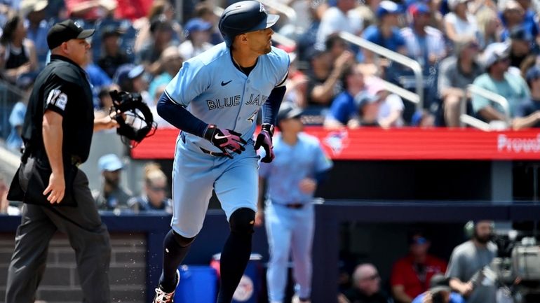 Toronto Blue Jays' George Springer, front right, watches his solo...