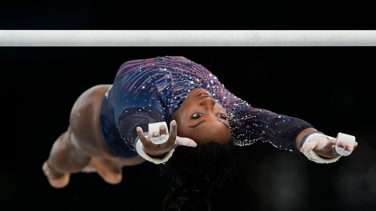 Simone Biles of the United States practices the uneven bars...