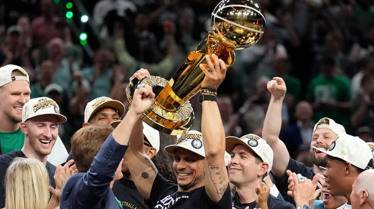 Boston Celtics head coach Joe Mazzulla, center, celebrates with the...