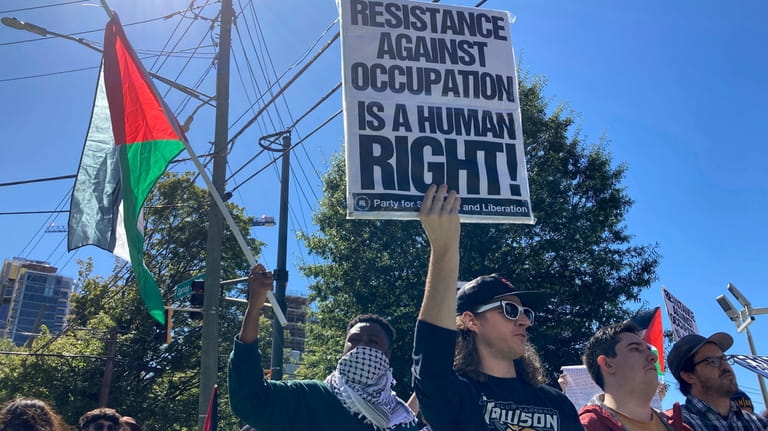 Pro-Palestinian demonstrators chant slogans outside the Israeli consulate in Atlanta...