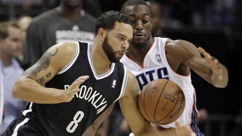 Deron Williams (8) loses the ball to the Charlotte Bobcats'...