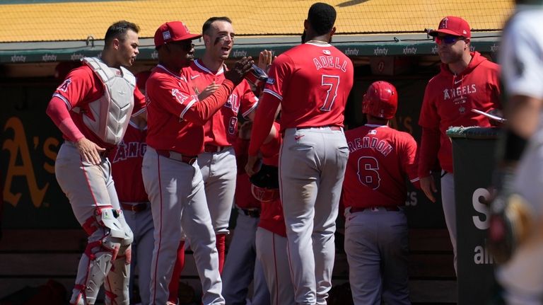 Los Angeles Angels' Jo Adell (7) is congratulated by manager...