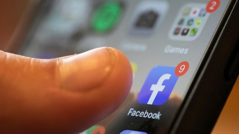 An iPhone displays the Facebook app, Aug. 11, 2019, in...