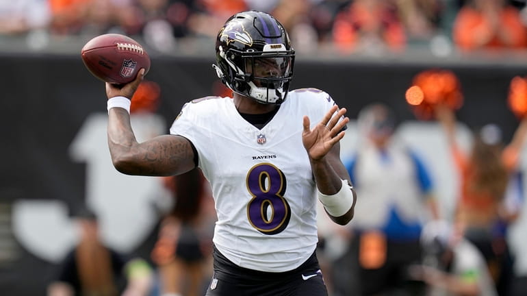 Baltimore Ravens quarterback Lamar Jackson throws during the first half...