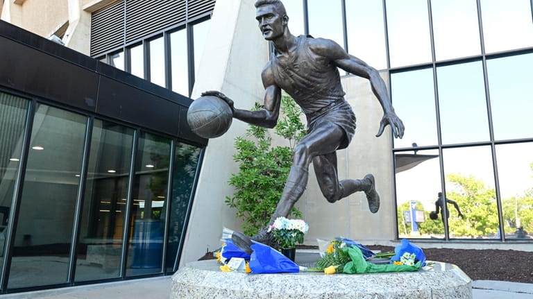 Flowers have been left at the Jerry West statute at...