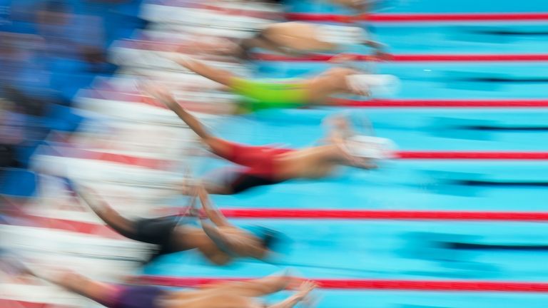 Swimmers compete during a heat in the men's 100-meter breaststroke...