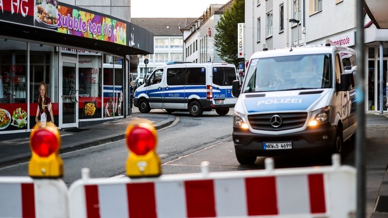 Police cars sit at a cordon early Saturday, Aug. 24,...