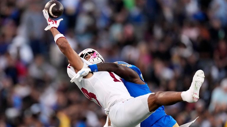 Indiana wide receiver Elijah Sarratt, left, can't hold on to...