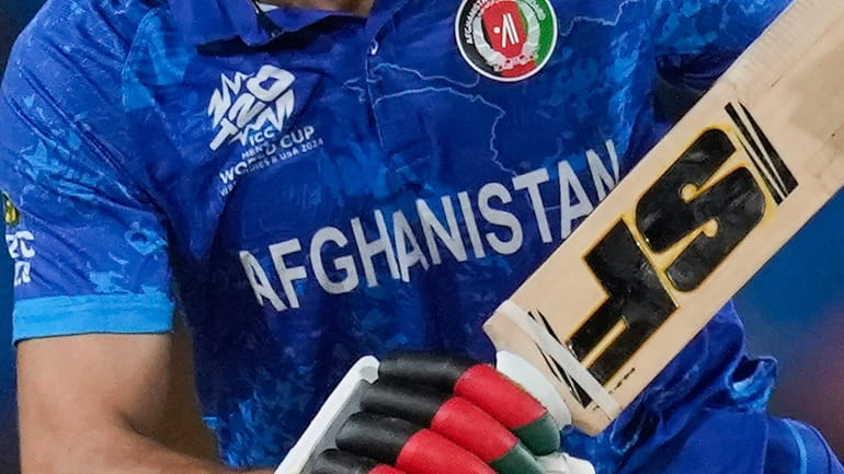 Afghanistan team logo is seen on a player's uniform during...