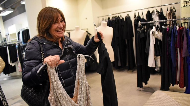 Customer Susan Ehrlich of Melville browses through formal dresses at...