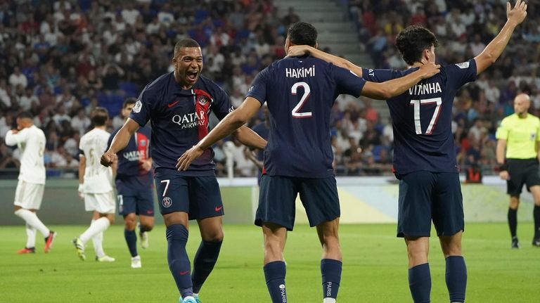 PSG's Achraf Hakimi, centre, celebrates with Vitinha, right, and Kylian...