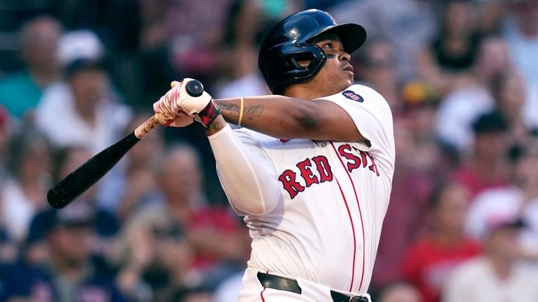 Boston Red Sox's Rafael Devers watches the flight of his...