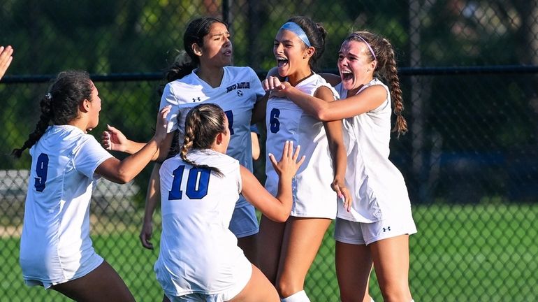 Brook Milheiser of North Babylon celebrates with teammates after putting the winning...