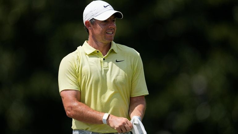 Rory McIlroy, of Northern Ireland, walks on the third green...