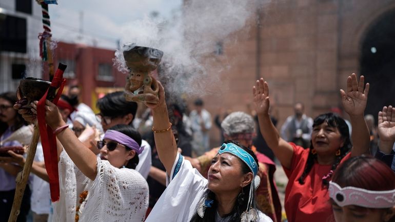 Residents and members of an Amaxac Indigenous organization perform a...