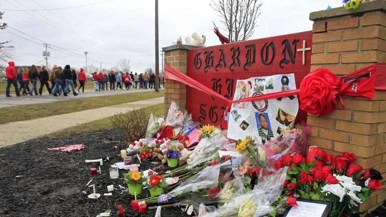 Hundreds of students and parents march to the Chardon High...