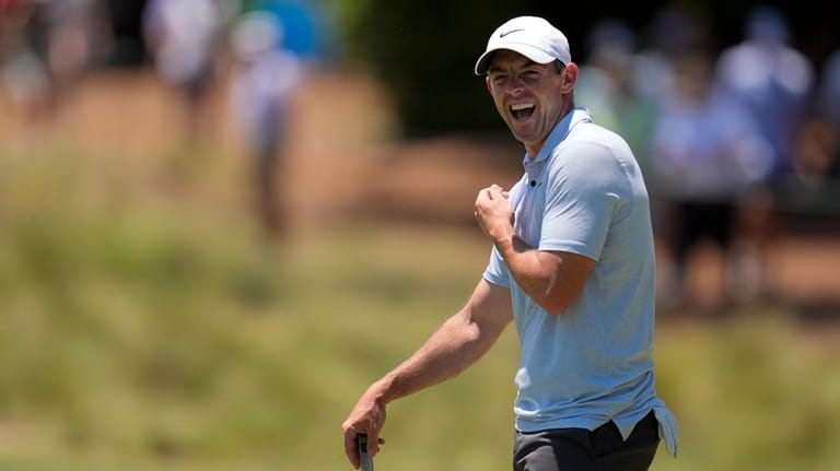 Rory McIlroy, of Northern Ireland, smiles on the first hole...