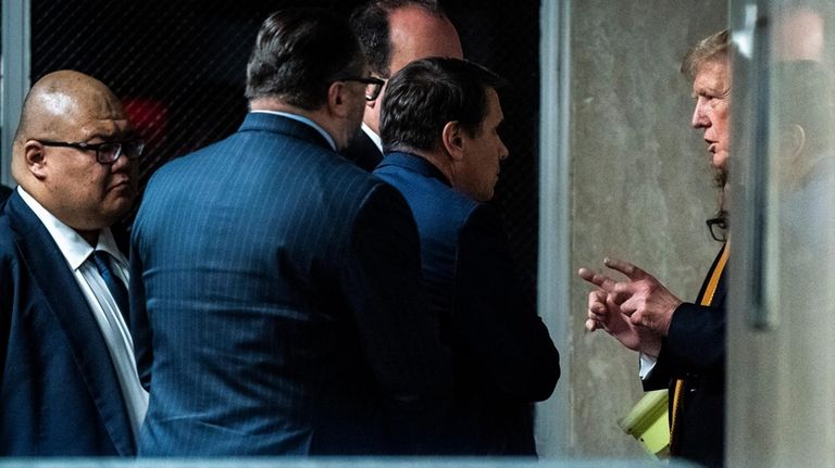 Former President Donald Trump speaks with attorney Todd Blanche and...