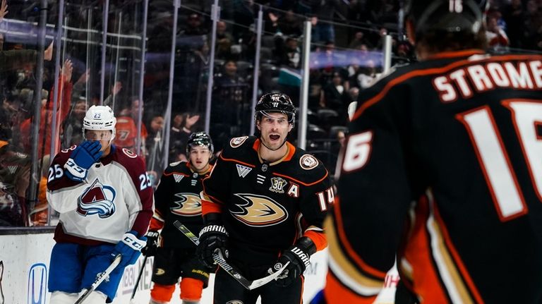 Anaheim Ducks center Adam Henrique, center, celebrates his goal with...