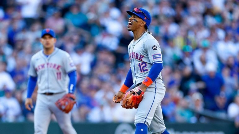 Francisco Lindor #12 of the New York Mets reacts after...