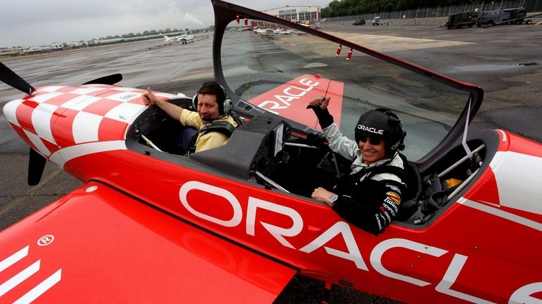 Legendary aerobatic air show performer Sean D. Tucker, right, and...