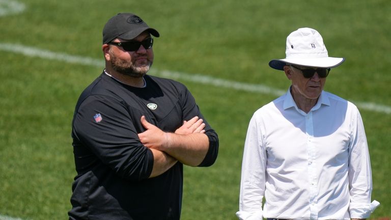 New York Jets owner Woody Johnson, right, talks with general...