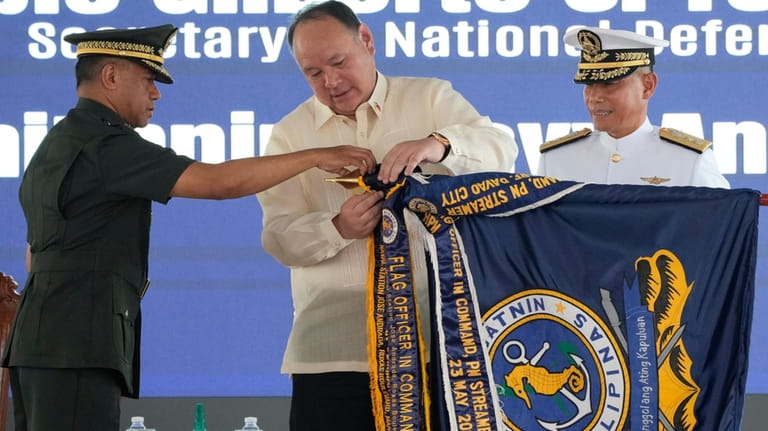 Philippine Defense Secretary Gilberto Teodoro, center, and military chief Romeo...