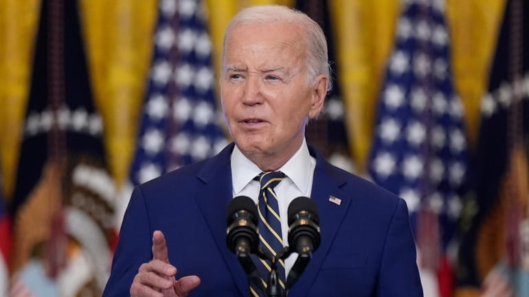 President Joe Biden speaks in the East Room at the...