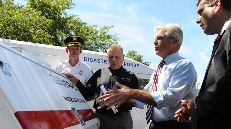 Suffolk County Executive Steve Bellone looks over a generator after...