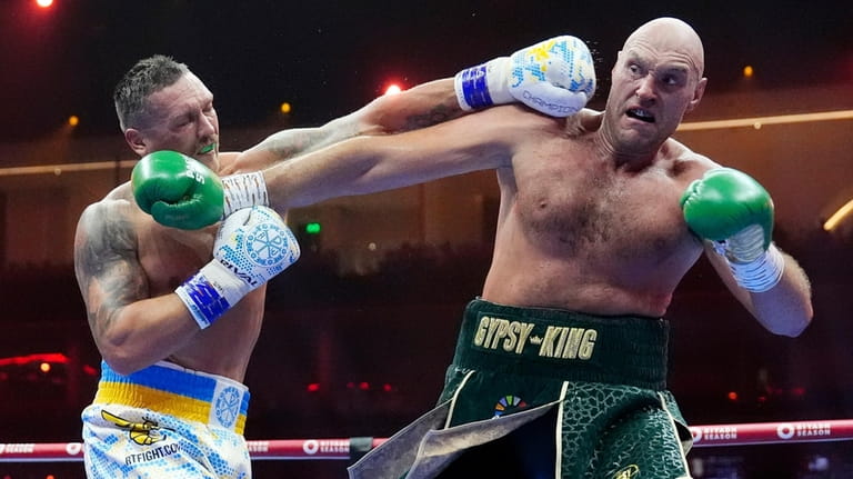 Britain’s Tyson Fury, right, and Ukraine’s Oleksandr Usyk exchange blows...
