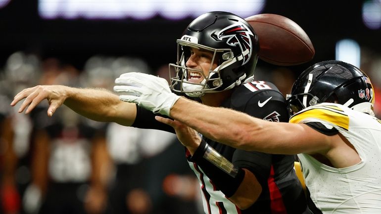 Atlanta Falcons quarterback Kirk Cousins (18) loses the ball as...