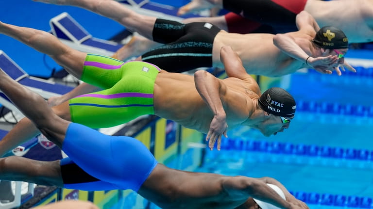 Ryan Held swims during a Men's 50 freestyle preliminary heat...