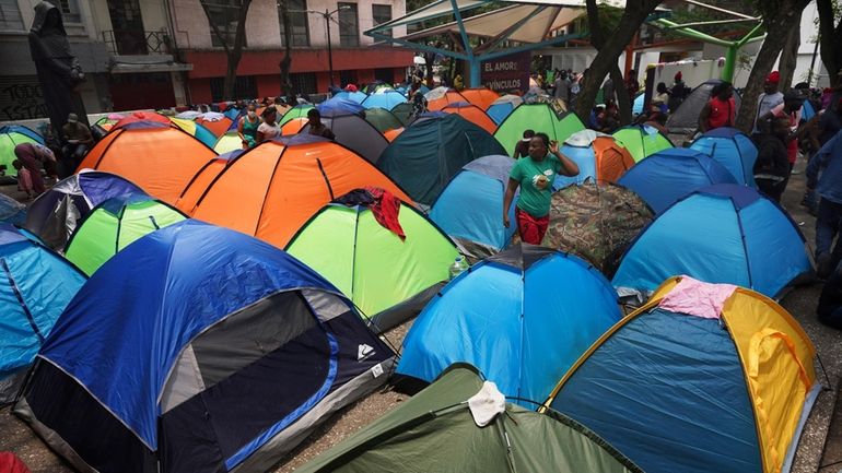 Haitian migrants camp out at Giordano Bruno plaza in the...